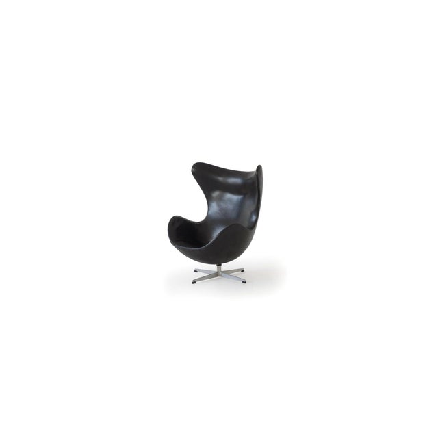 Mid Century Modern Arne Jacobsen 1958 Egg chair by Fritz Hansen. First edition with Solid aluminum black leather. Make a...