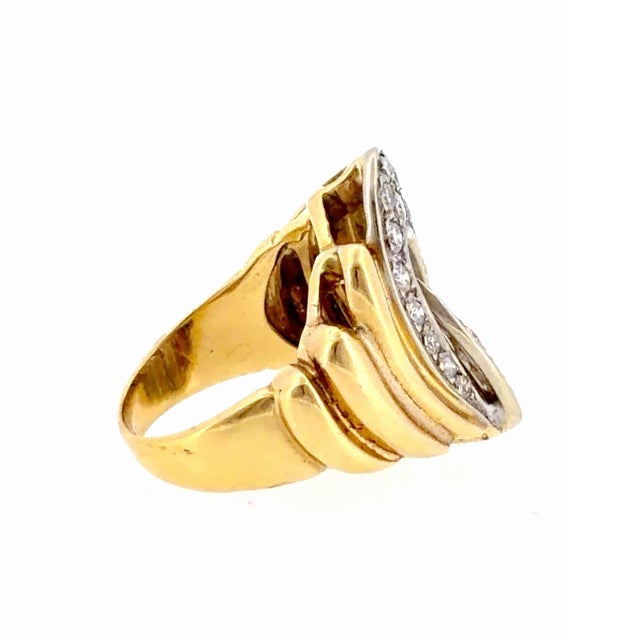 Vintage 18K two-tone cocktail ring, featuring a pave diamond set white gold center with an interlocking swirl design...