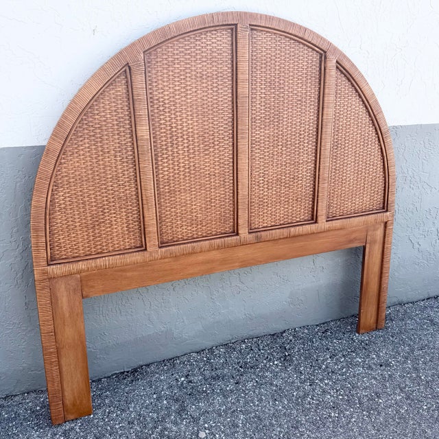 A stylish Boho Chic queen-size headboard featuring a dramatic arched silhouette and warm woven wicker construction. The...