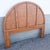 A stylish Boho Chic queen-size headboard featuring a dramatic arched silhouette and warm woven wicker construction. The...