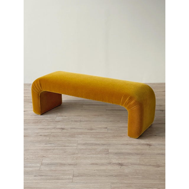 Vintage 1980s waterfall bench, newly reupholstered in golden ochre mohair. The elongated seat curves downward at both ends...
