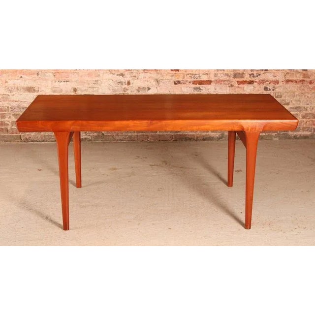 Danish Mid Century teak dining table by Ib Kofod Larsen for Faarup Mobelfabrik, circa 1960s. 2 extension leaves stored...