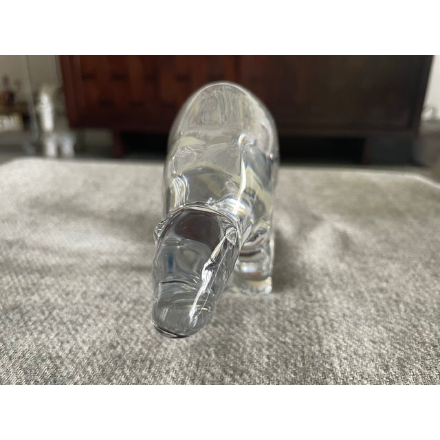 Baccarat Crystal Polar Bear figurine. This collectible features a sleek, minimalist silhouette crafted from heavy clear...