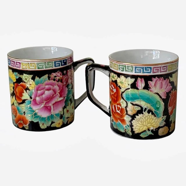 A vintage pair of Chinoiserie Mugs with black background and colorful gilded flowers and Greek trim designs. A great...