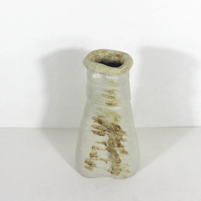 Width: 3.5 inches Height: 6.75 inches Depth: 2.5 inches Primitive, organic studio pottery vase in neutral colours. Rustic...