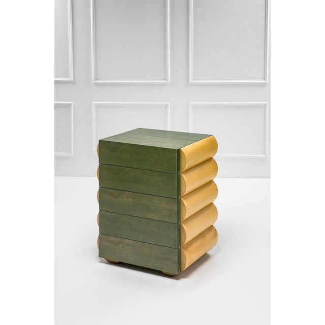 Chest of drawers in natural wood and aniline-stained wood. Postmodern style. 1980s