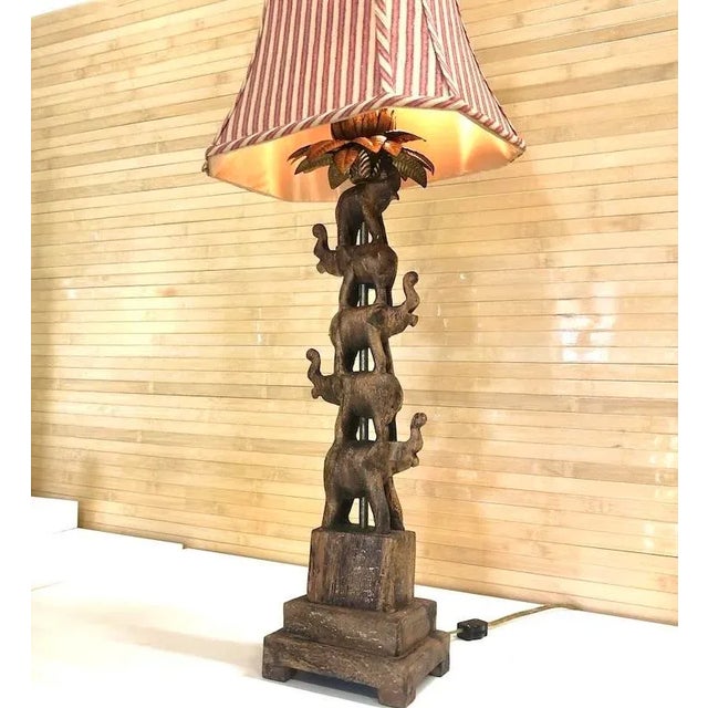 5 elephants stacked atop each other under gilt metal palm leaves and flower. Holds 2 candelabra size bulbs. On-off cord...