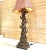 5 elephants stacked atop each other under gilt metal palm leaves and flower. Holds 2 candelabra size bulbs. On-off cord...
