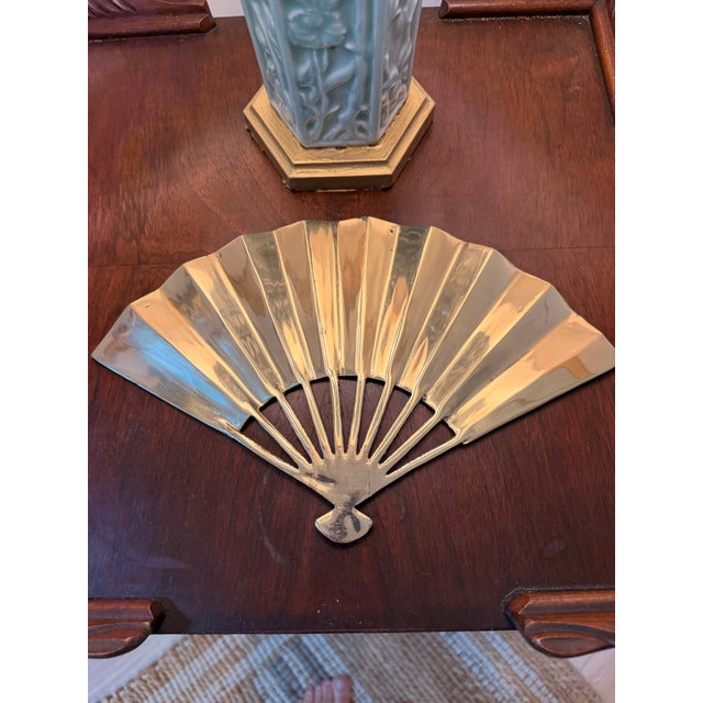 This vintage brass fan-form plaque features a detailed relief of the Fenghuang, the Chinese Phoenix, surrounded by...