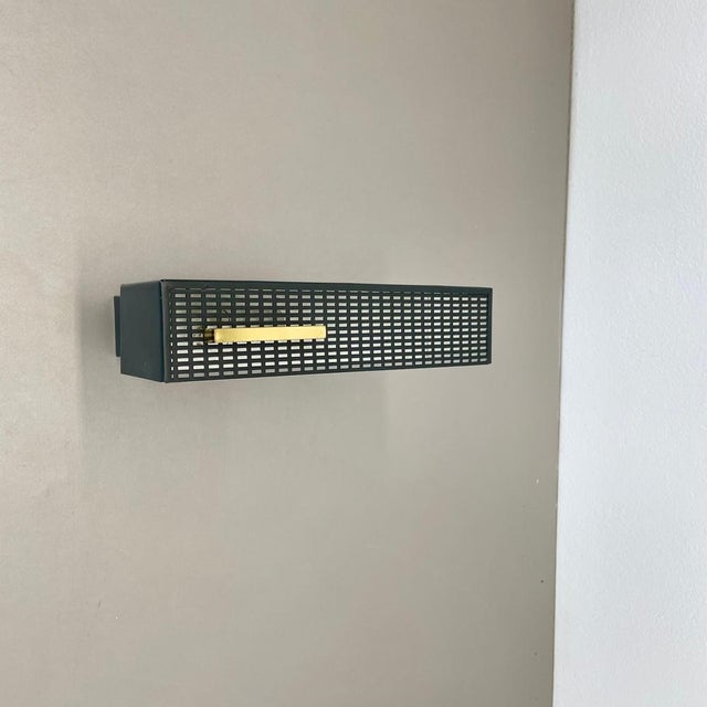 Article: wall light Origin: Germany Material: Metal and brass Age: 1950s This original vintage wall light was designed in...