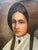 Striking 1920s folk art portrait of a young woman from the 1840s. She’s wearing a brown bonnet of the mid nineteenth...