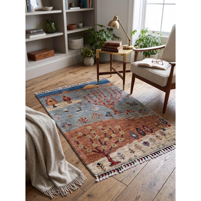 A small hand-knotted Gabbeh rug in the Persian Gabbeh tradition, woven as a landscape: a golden sun setting behind brown...