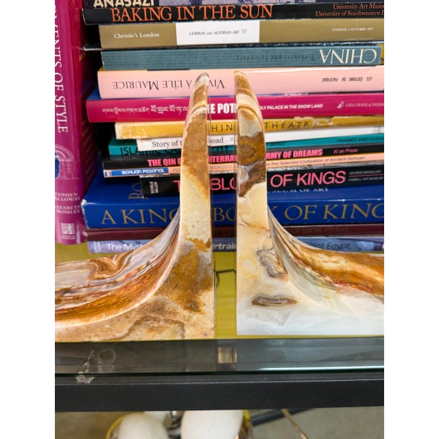 Pair of onyx bookends that have an olympic style slope to them. Solid, heavy and ready to hold and display all size books.