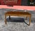 An exquisite Mastercraft dining table with striking burl accented throughout the table and gold trim along the border....
