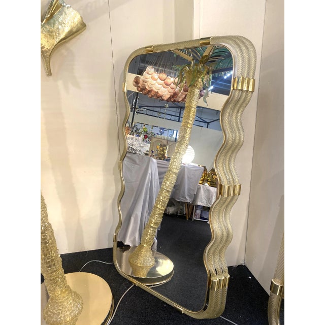 Scenographic luxury wall mirror in Murano glass full of gold-leaf. Solid Detail in brass. A luxury piece of italian art....