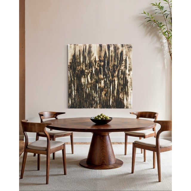 Factum by J. Kent Martin is a deeply tactile abstract built from layered grays, blacks, and mineral whites, anchored by a...