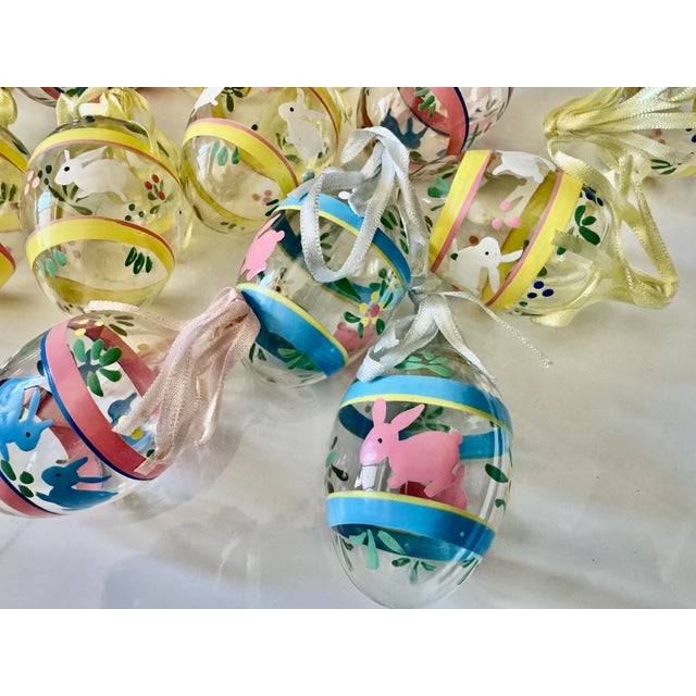 Set of fourteen vintage 1980s hand painted with Easter motif bunnies and flowers pastel palette, glass decorative eggs...