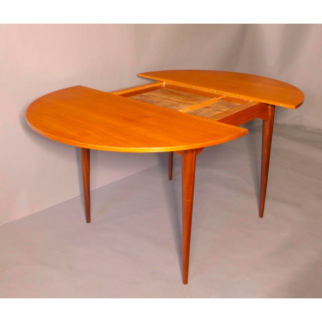 This fine dining table was made in Italy in the 1960s. It has a circular 120 cm top and an extra leaf folded underneath....