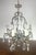 French ornate iron & crystal chandelier with a classic design. The ornate scrolling arms, candle-style lights, and...