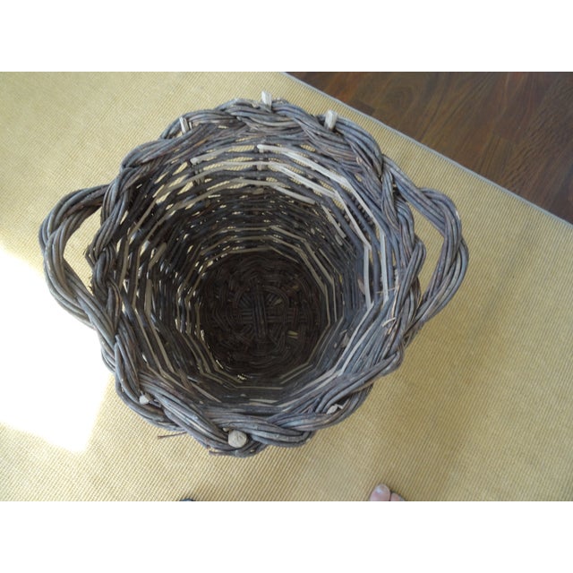 Large Wicker Basket with prominent handle. This would be a great firewood basket or a wonderful container for plants.
