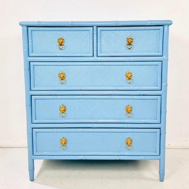 Vintage chest of drawers featuring faux bamboo framing and woven wicker drawer fronts, finished in glossy baby blue...
