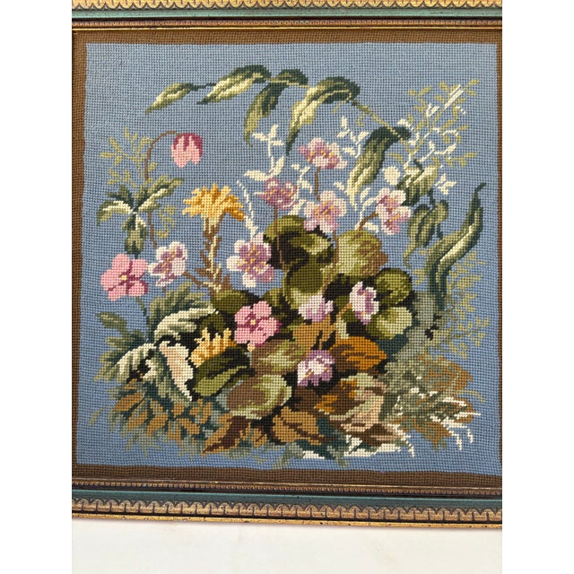 A beautifully hand-stitched vintage floral needlepoint tapestry, featuring a lush bouquet of pastel blooms against a...