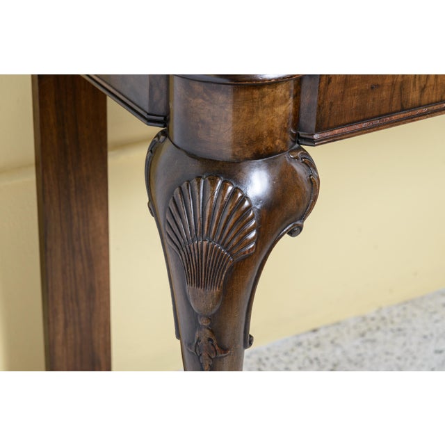 Pair of transitional English/Irish mahogany inlaid top consoles. Front cabriole legs have shell decoration and end with a...