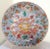 This is a large antique Asian charger that has beautiful finely detailed designs on the front and back.
