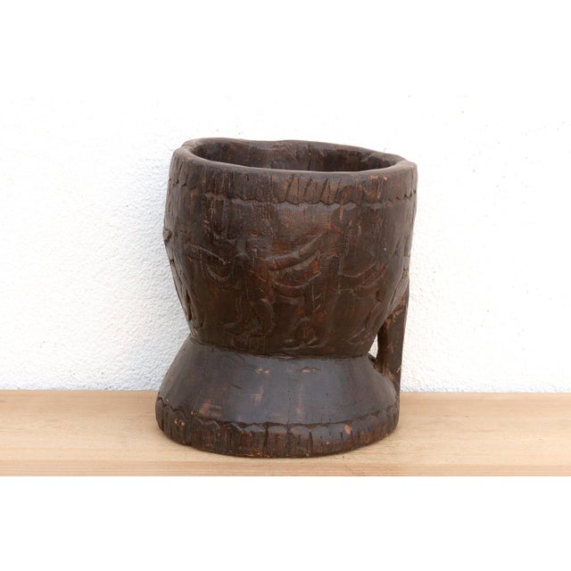 This dramatic vessel is a genuine piece of Primitive Treenware and Tribal Art, transforming a functional grain or spice...
