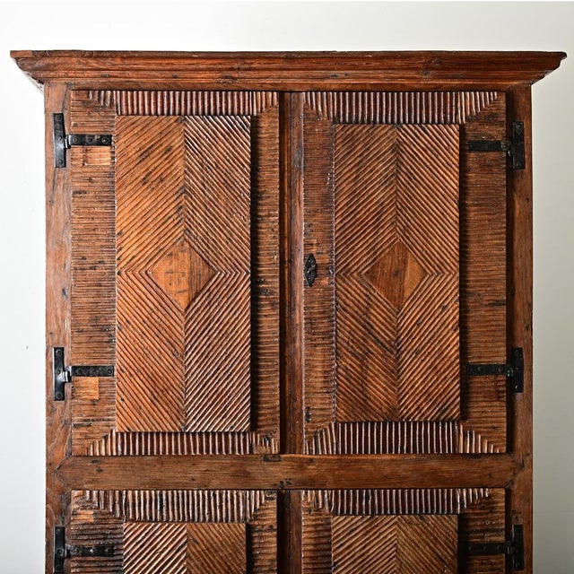 Dimensions: 82.38" H x 56" W x 28.38" D A substantial carved cabinet from Portugal, 18th century if not earlier, made of...
