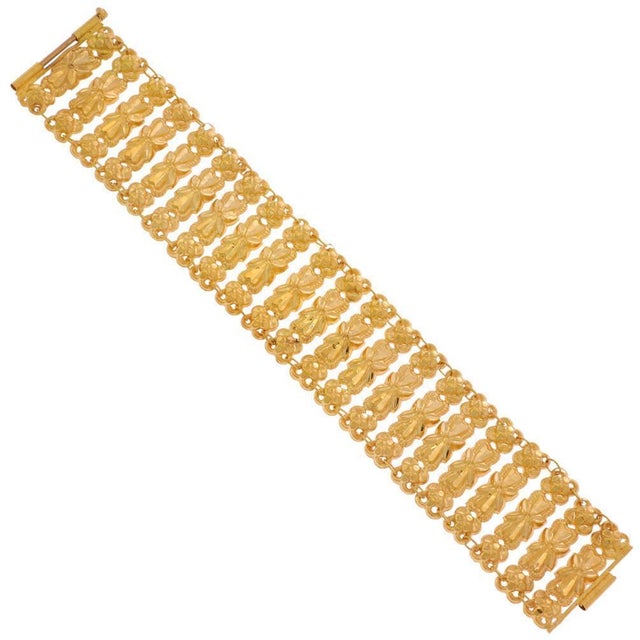 This is an eye catching vintage bracelet, crafted from 22k yellow gold featuring long embossed floral bar links, each...