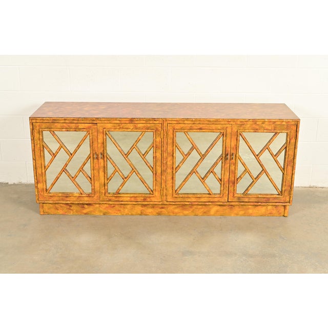 An exceptional mid-century modern Hollywood Regency mirrored sideboard, credenza, or bar cabinet In the manner of Henredon...