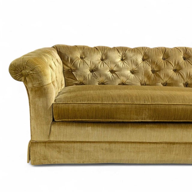 Vintage Hollywood Regency Gold Velvet Tufted Sofa. A long, low vintage sofa upholstered in warm gold velvet, combining...