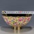 A vibrant Chinese porcelain bowl featuring a bright yellow ground decorated in a dense "Millefleur" (thousand flowers)...