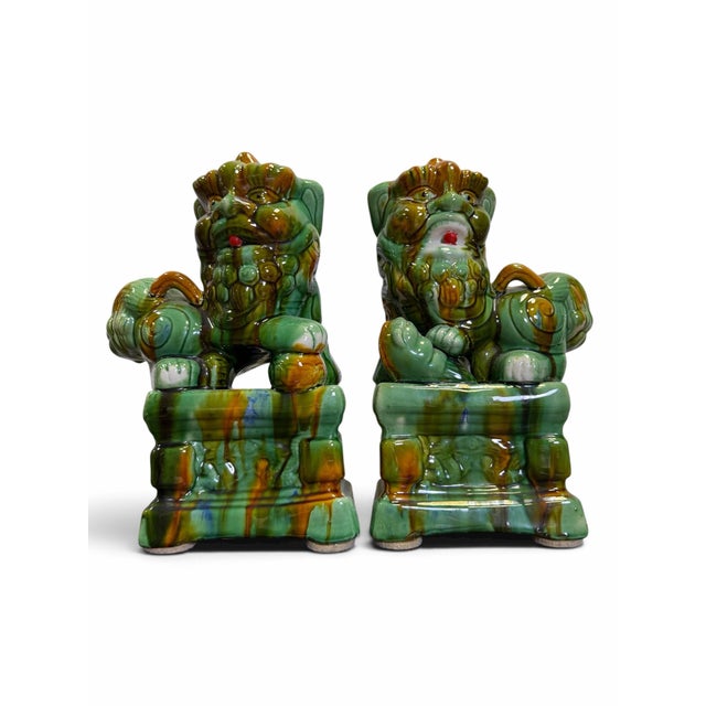 An incredibly vibrant and charismatic pair of vintage mid-century ceramic Chinese Foo Dogs (Imperial Guardian Lions). This...