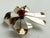 A darling sterling silver brooch, fashioned as a three-loop bow, set with a red, faceted gemstone.