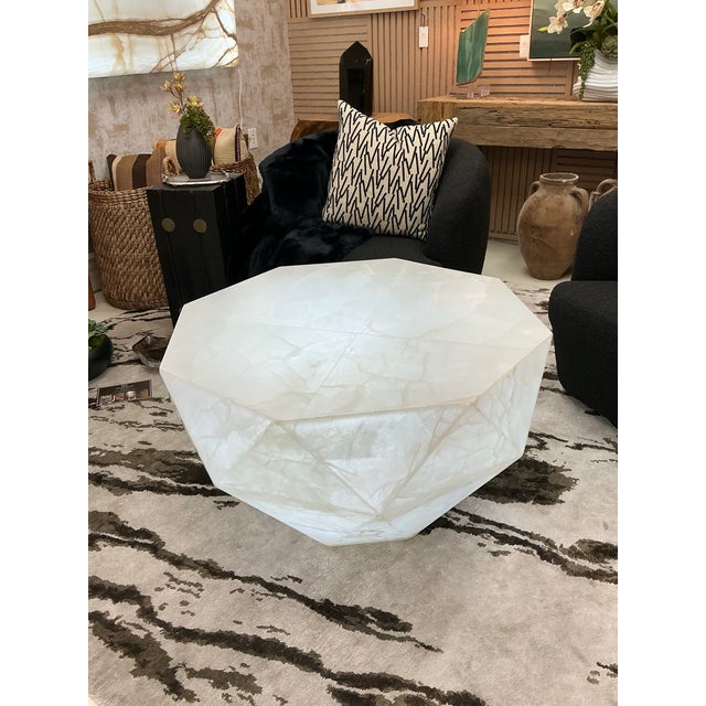A true statement piece, this sculptural coffee table is hand-carved from natural white onyx in a striking diamond shape....