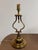 Design Plus Gallery presents a Vintage Lyre Form Brass Tone Table Lamp. This table lamp showcases a classical lyre-...