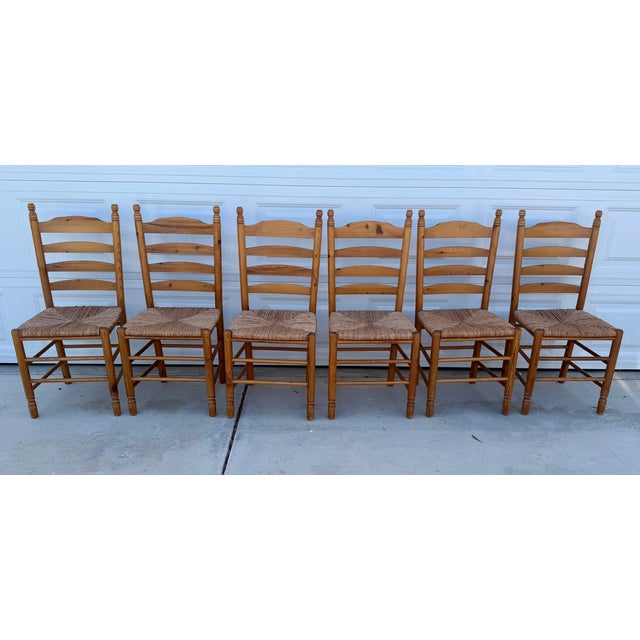 A set of 6 rush seated Shaker style ladder back chairs circa 1960s in great condition! Very sturdy pine construction with...