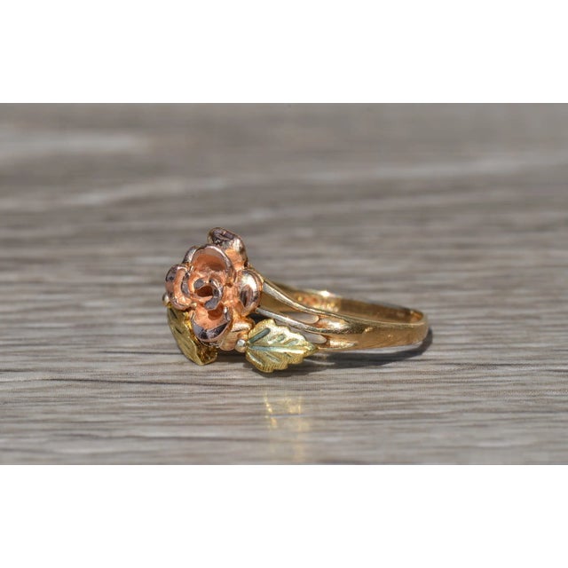 The Novalee Ladies Vintage Two Tone Floral Cocktail Ring. This vintage ring exhibits a delicate floral design detailed in...