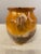 An earthenware confit pot from the Southwest of France with traditional yellow, ochre glaze. Some chips and losses to...