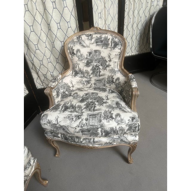 Vintage gilt bergere chairs carved in the Louis XVI style, curvaceous frames, cabriole legs and ornamental cresting. These...