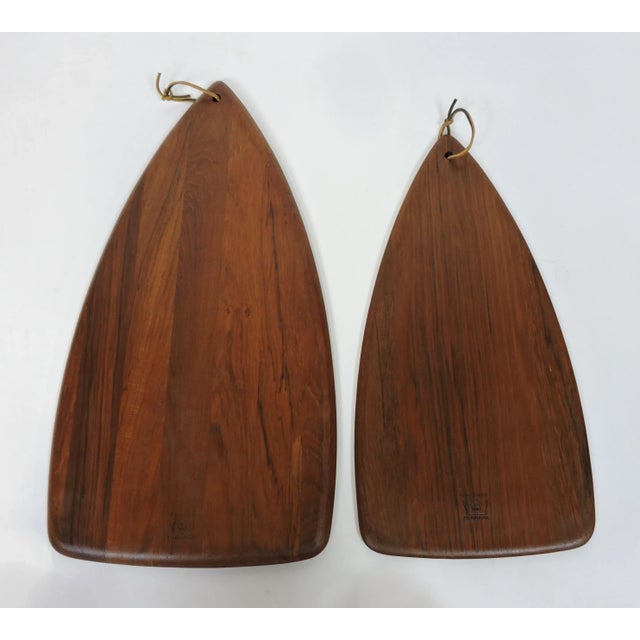 Beautiful set of two Digsmed of Denmark teak cutting boards. The larger one is 22 inches long and the smaller is 18.5...