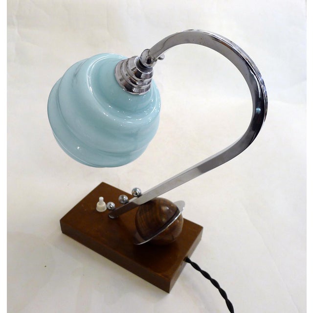 Modernist Art Deco sculptural table/bedside lamp, circa 1930. Rectangular wooden base with a small push-button switch;...