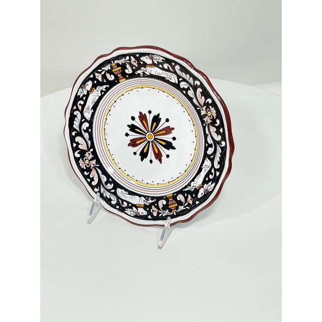 This black and dark red Full Design Salad Plate from Biordi features the figure of a sitting deer. This classic and...