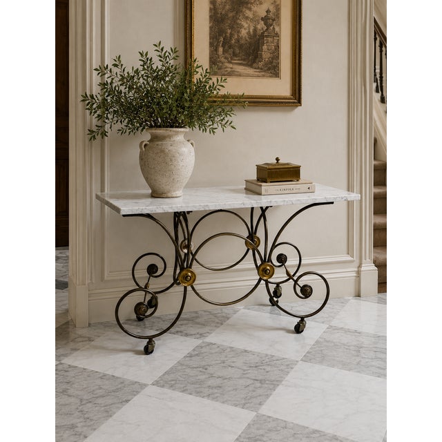 This mid-century Reproduction French Patisserie table, crafted from steel and brass, boasts a rectangular white marble top...