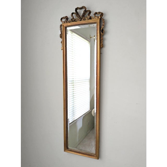 A late 20th century French Louis XVI style dressing mirror by Carolina Mirror Company. The mirror has a beautifully carved...