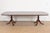An exceptional Georgian or Regency style double pedestal extension dining table In the manner of Baker Furniture USA, Late...