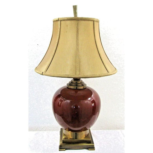 Pair of Uttermost Daviel Oxblood Red Porcelain and Coffee Bronze Stepped Base Table Lamps Style 26728 These lamps have a...