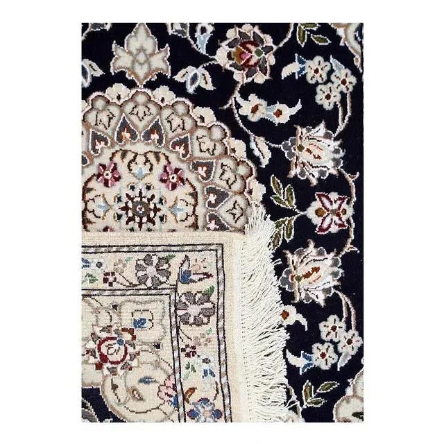 Persian Nain rugs are renowned for their detail and fine use of outlining along the central motifs. Breaking from the...